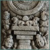 Ancient carving with pillar and celestial disc